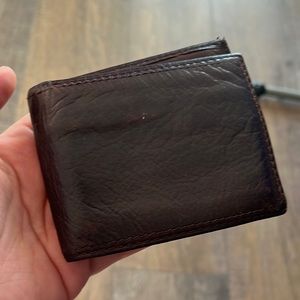 Fossil bifold dark brown wallet preowned 8.25 inches by 3.25 inches.